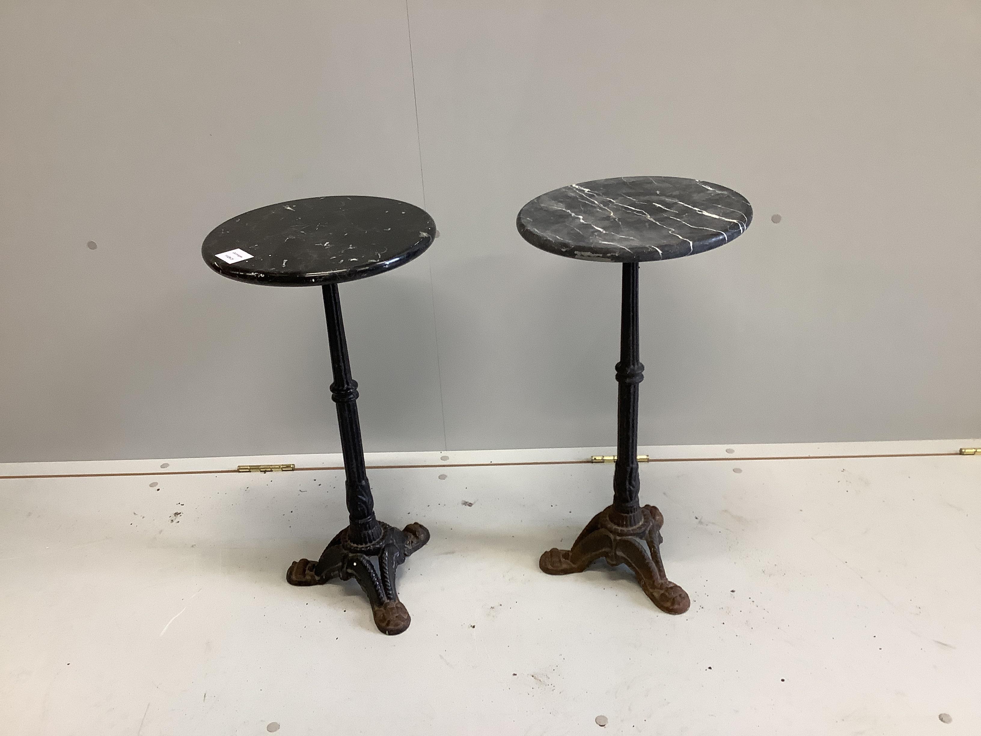 A pair of Victorian style cast iron circular marble topped occasional tables, diameter 30cm, height 59cm